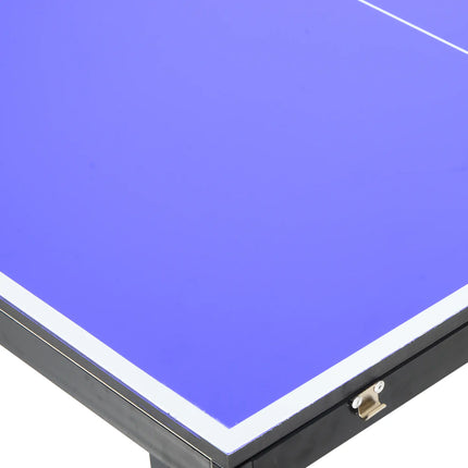 Foldable ping pong table with paddles and net set up indoors